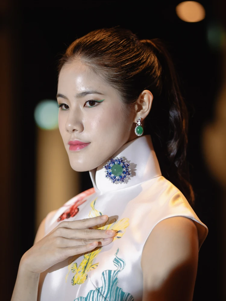 Model wearing DeGem jadeite brooch and earrings styled with a qipao, demonstrating how fine jadeite jewellery is worn in a contemporary Malaysian context